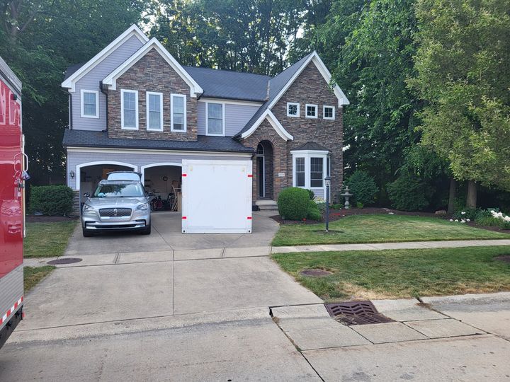 Two-story stone and siding home with a driveway (Onsite Moving Services) by Affordable Moving Solutions of Ohio