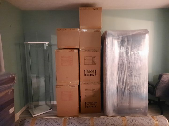 Packed boxes and a shrink-wrapped mirror (Packing services) by Affordable Moving Solutions of Ohio